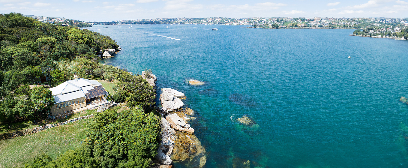 An aerial view of Steel Point Cottage with Sydney Harbour and Sydney City views in the background. Credit: Gareth Pickford © DCCEEW