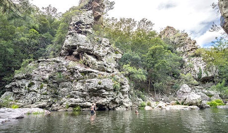 Hikers enjoy a swim at a waterhole in the gorge on Green Gully Track. Credit: David Waugh &copy; DCCEEW