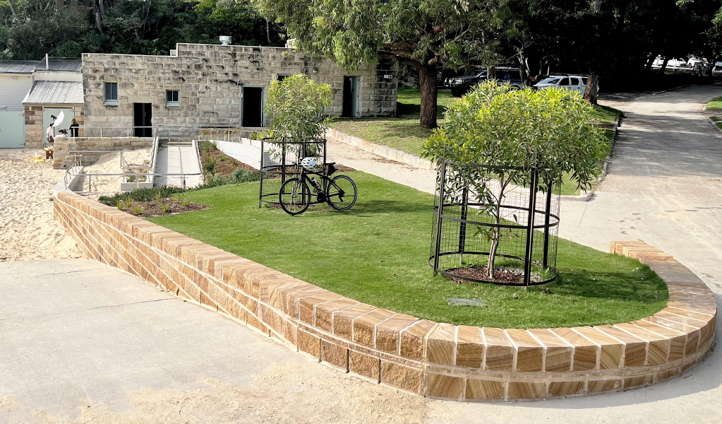 There's an accessible ramp from the promenade to the beach and accessible toilets in the sandstone building behind it.  Photo: Natasha Webb &copy; DCCEEW